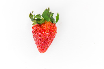 One fresh red strawberry isolated on white 