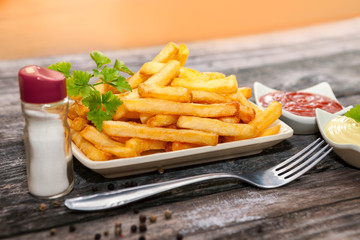 Plate with french fries and big fork