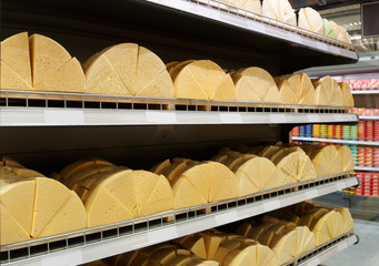 Sold by weight cheese on supermarket shelf