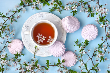 Spring composition with blossom branch,  tea cup and sweet zephyr