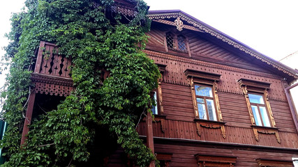 Fototapeta na wymiar Old wooden house, windows on the facade. House in the village