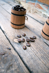 Coffee beans in a barrel on a wooden.