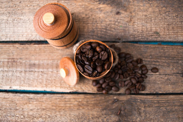 Coffee beans in a barrel on a wooden.