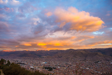 Panoramic view of Cusco town with glowing cloudscape and colorful sky at dusk. Cusco is among the most important travel destination in Peru and the entire South America.