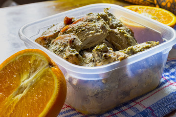 Boiled chicken breast with dill in kefir with orange on the table. Ducan's diet