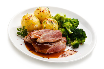 Grilled beefsteak with broccoli and carrot on white background 