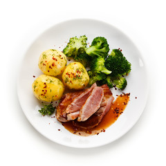 Grilled beefsteak with broccoli and carrot on white background 