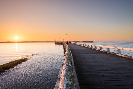 Sunset over the pier of Oostende, Belgium.