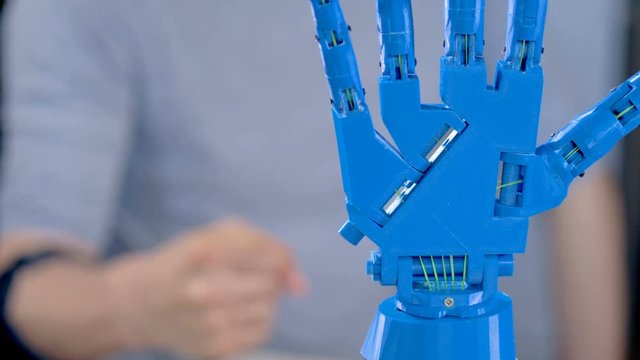 A bionic arm in close view works showing its hinges.