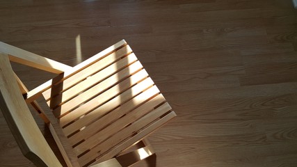 Sun light shine on the wooden chair.