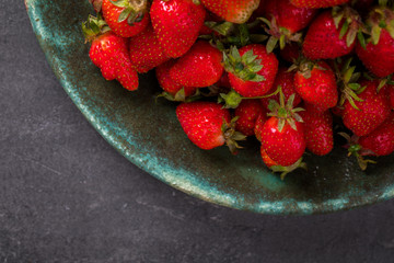 Fresh strawberry on the Plate.Berry Sweet on a grey Background.Food or Healthy diet concept.Super Food.Vegetarian.Copy space for Text. selective focus.