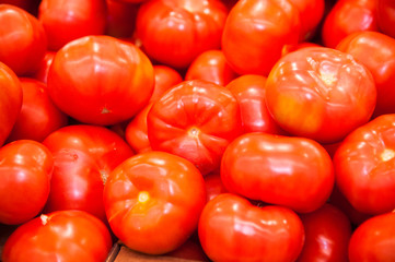 Fresh ripe tomatoes in a box for sale in the grocery shop