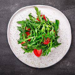  Salad with arugula , Fresh Cherry Tomatoes and Olive oil.Food or Healthy diet concept.Super Food.Vegetarian.Top View.Copy space for Text.