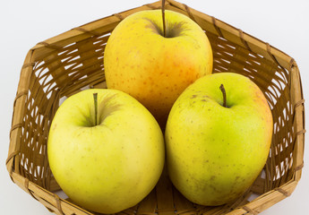 Fresh, Ripe apples in basket on white background.