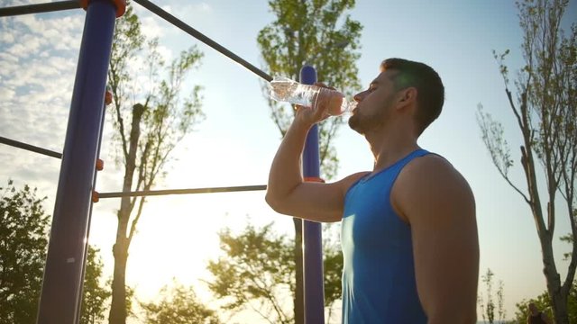 Strong Guy Drink Clean Water From Bottle After Sports Workout slow motion