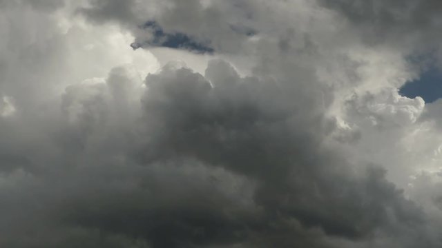 Heavy dark clouds floating in the sky. Time-lapse recording. 4K, Ultra HD, UHD