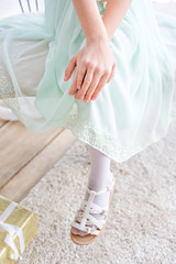 Beautiful little girl in mint dress celebrates her birthday