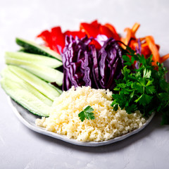 Buddha Bowl Vegetarian .Raw Vegetables and  in Couscous a one bowl.Food or Healthy Diet concept.Super Food.Copy space for Text. selective focus.