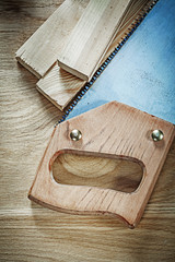 Obraz na płótnie Canvas Set of hacksaw timber on wood board construction concept