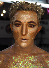 Young boy at the art make-up as golden caesar with red eyes - obrazy, fototapety, plakaty