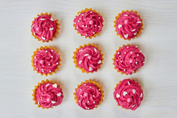 Pink cupcakes decorated with pearls and hearts