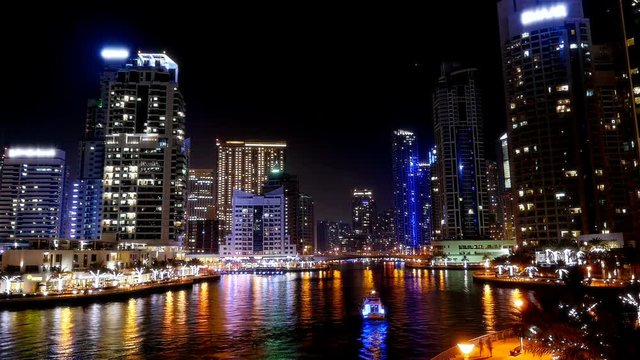 Night time lapse with boats and people in Dubai Marina