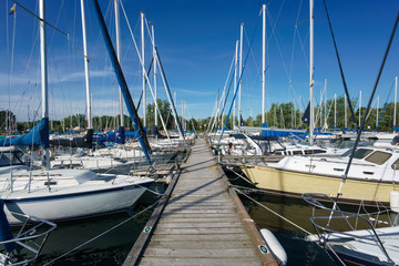 Stationary sailing boats alongside a pier, Toronto, Ontario, Canada, summer.