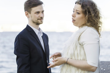 Woman tells something to a man