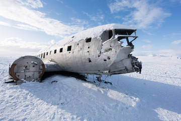 Old plane wreck on snow covered landscape by day, Iceland, Europe.