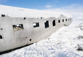 Old plane wreck on snow covered landscape by day, Iceland, Europe.