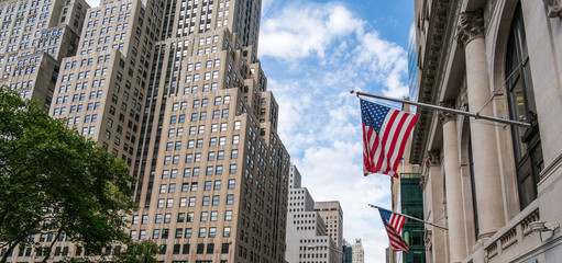 American flags hanging from building exterior, New York City, USA.