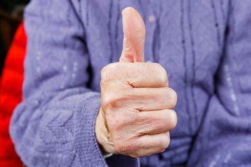 Elderly woman show thumbs up
