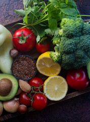 Organic vegetables,fruit, herbs,nuts,seeds in wooden box for healthy lifestyle, raw vegan diet, selective focus, top view