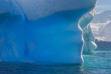 Foto op Canvas Blue shimmering beautiful iceberg in Antarctica © Achim Baqué