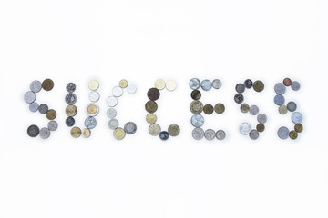 Success word  created with coins.