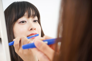 Young woman brushing her teeth