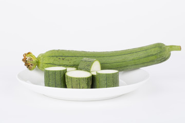 Fresh loofah in a white plate.