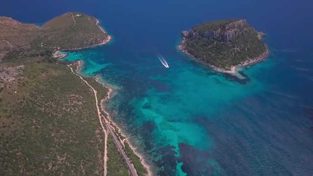 Video from above. Aerial view of a turquoise beach and a beautiful lighthouse. Emerald coast, ,Sardinia, Italy	