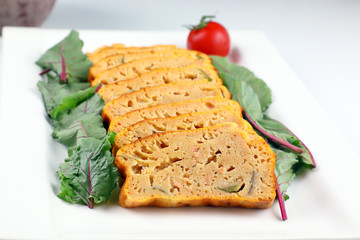 Meatloaf slice red chard leaf .