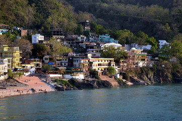 Fototapeta na wymiar View of the embankment of the Ganges in Rishikesh, one of the holy Hindu cities in India