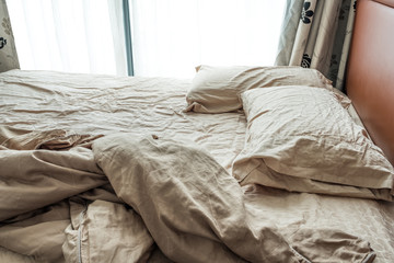 Fototapeta na wymiar crease of an unmade bed sheet in the bedroom