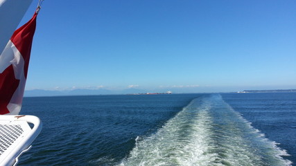 flag at ferry tail ocean skyline