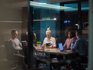 Multiethnic startup business team in night office