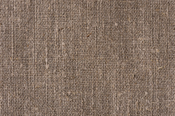 Brown natural canvas rough rustic fabric texture.