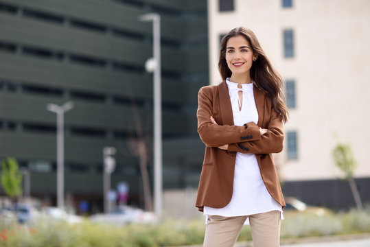 Young Woman With Nice Hair Standing Outside Of Office Building.