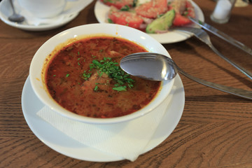 Traditional Georgian soup Kharcho with meat and rice on wooden background
