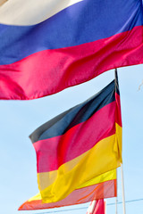 world waving flag in the blue sky  colour and spain