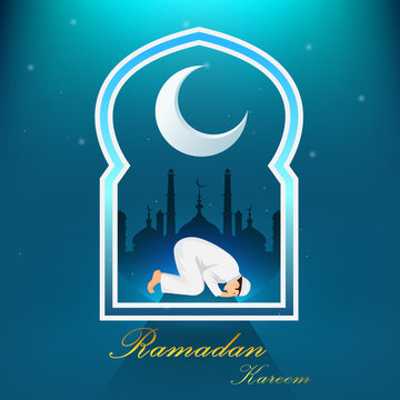 Young muslim man praying on blue background © TA design