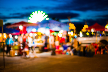 Blurred background of people shopping at night festival with bokeh