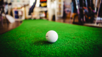 Golf club and ball in grass